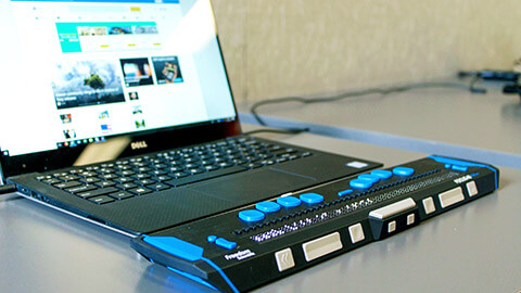 A close view of a braille keyboard used to assist an individual with a vision impairment to access the internet.