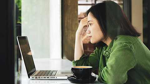 A designer looking at a laptop to see if everything is functioning correctly