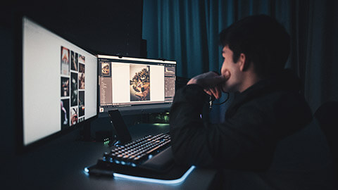 A designer working with a 2-screen desktop setup