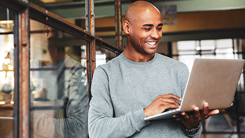 A designer working on a laptop in an office environment