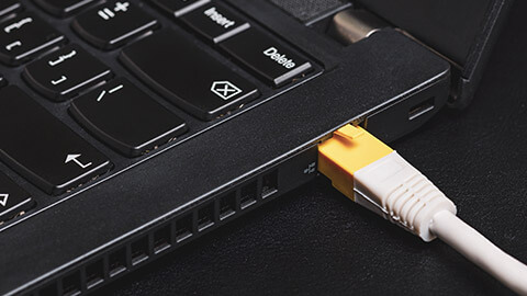 A close view of an ethernet cable plugged into a computer