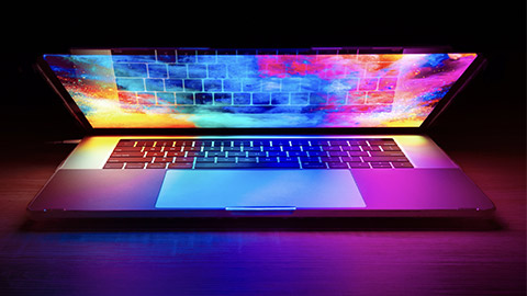 A laptop on a table with a large touchpad visible