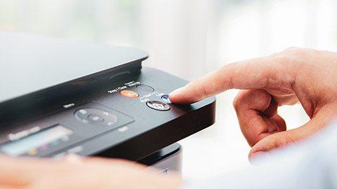 A person using a printer in an office