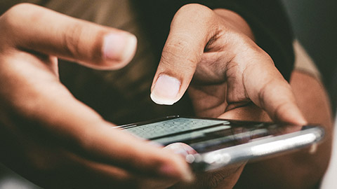 A close view of a person using a mobile phone