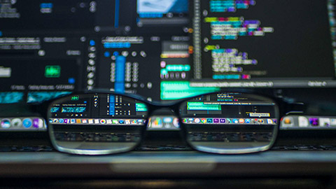 A pair of glasses on a laptop with software visible on the screen