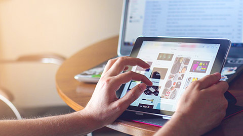 A close view of a person using a tablet device