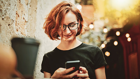 A young designer interacting positively with an app on her phone