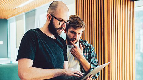 A programmer demonstrating a product to a fellow employee