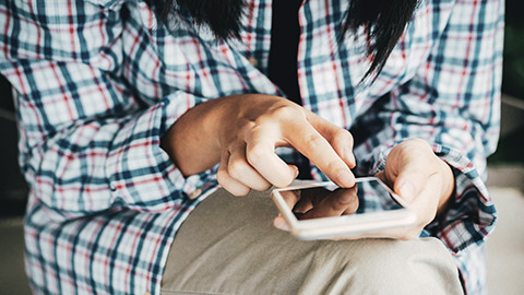 A person using a mobile phone to play a game