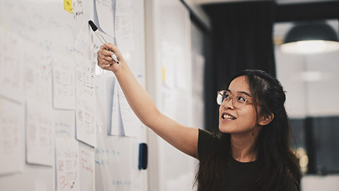 A developer pointing at things on a board