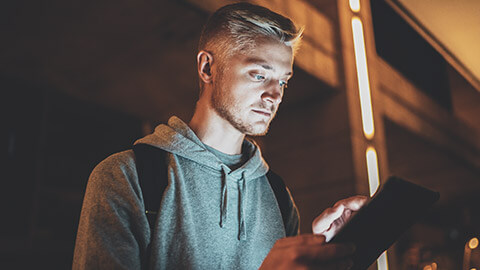 A young hipster consuming content on a tablet device