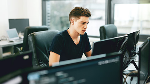 A programmer working in a modern office