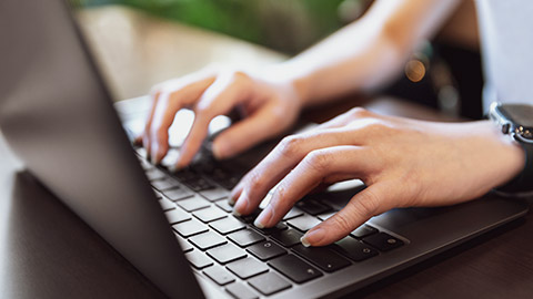 A close view of a person typing on a keyboard