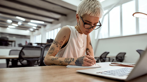 A hipster working at a desk