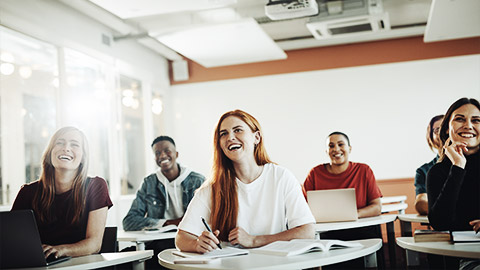 A group of students happily listening