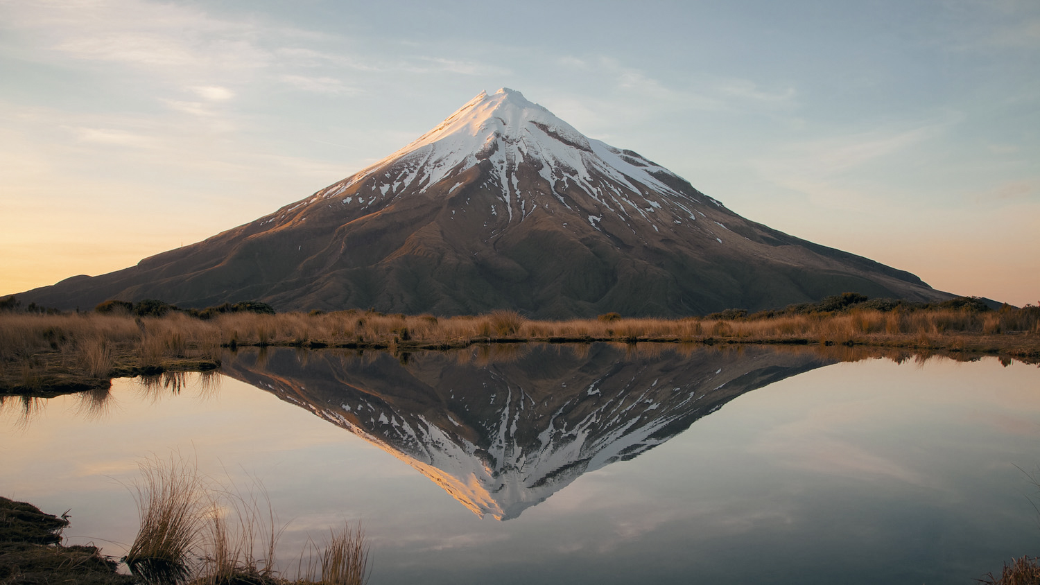 New Zealand's Mount Taranaki Reflected in The Pouakai Tarn at dawn.