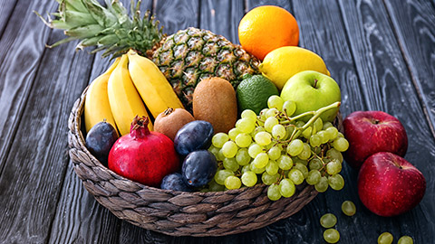 assorted fruit in a basket on a table
