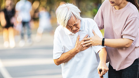 Elderly woman having heart attack