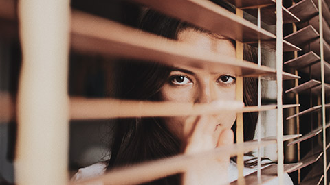 Female looking through a window