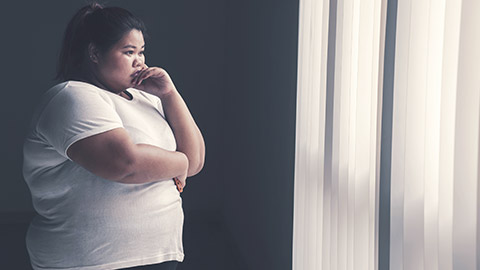 Overweight woman looking out the window