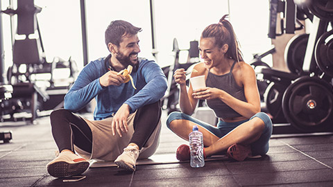 Young couple eating post-workout snack
