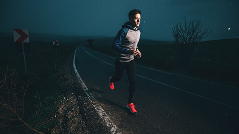 Male running outdoors at night