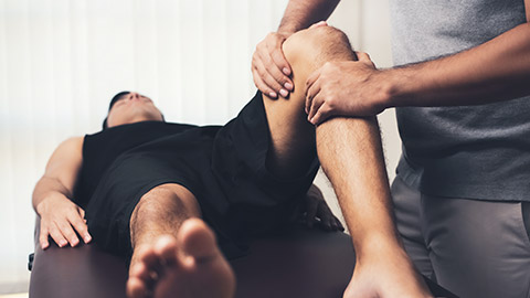 chiropractor working on knee