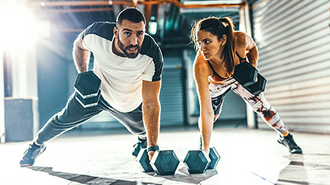 Male and female training in home gym