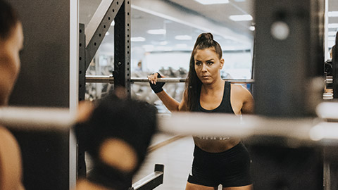 Woman focussed on lifting exercise