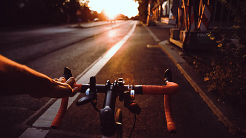 Person riding bike at sunset