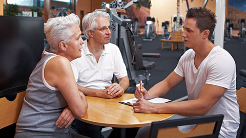 trainer consulting with mature clients