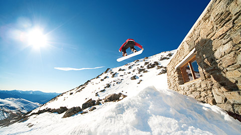 snowboarder in the air against a blue sky