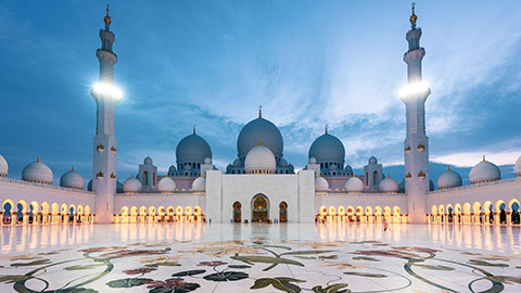 grand mosque in abu dhabi at sunset
