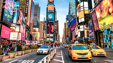 bustling times square area with iconic yellow cabs