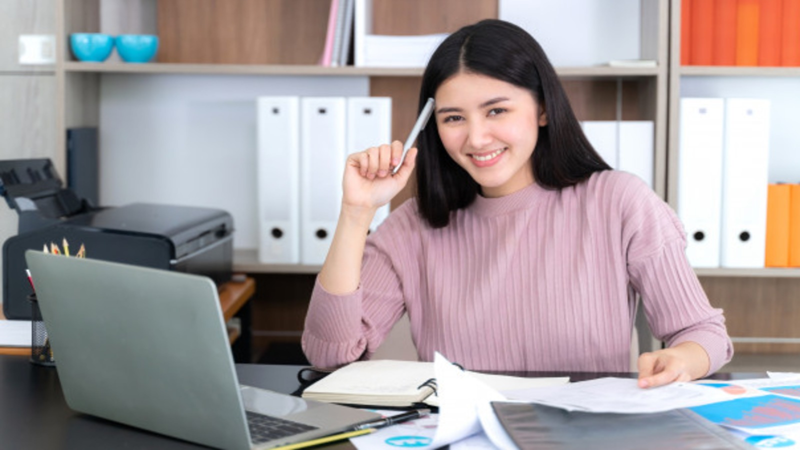 young business woman at an office desk with laptop