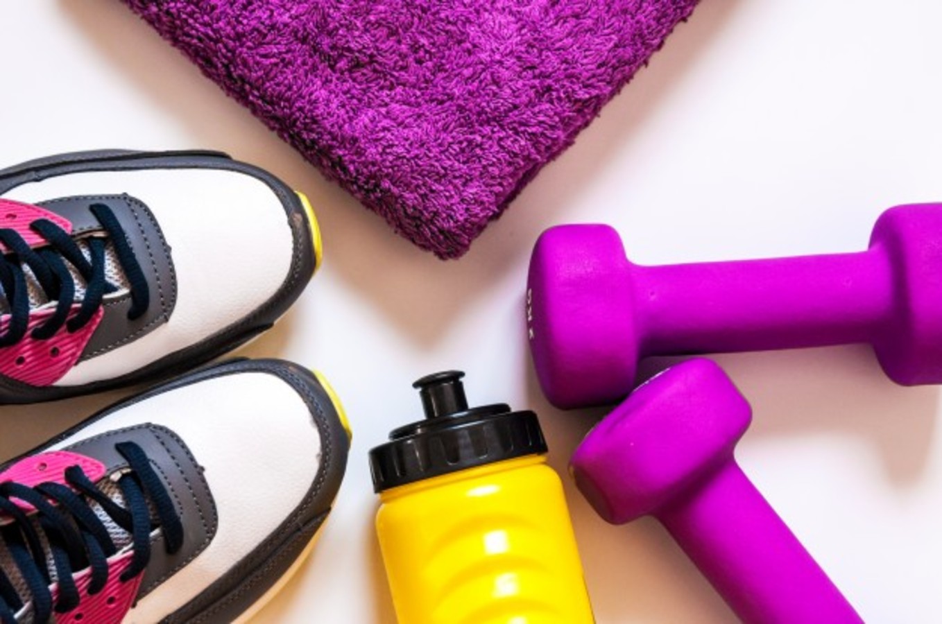 sports shoes towel bottle and dumbells