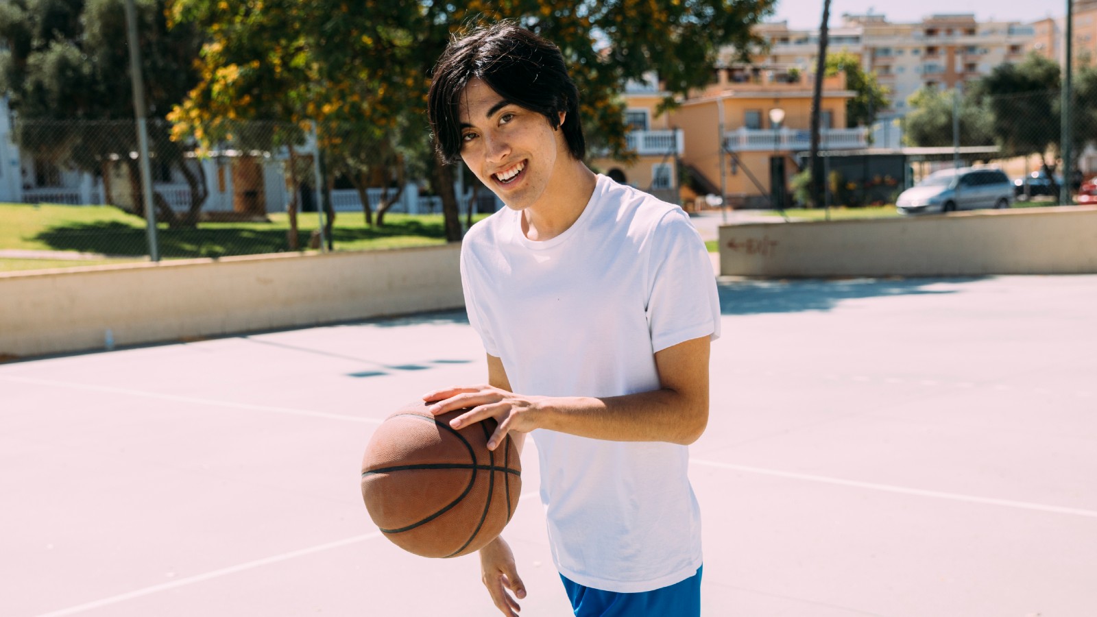 Teenage boy dribbling a basketball