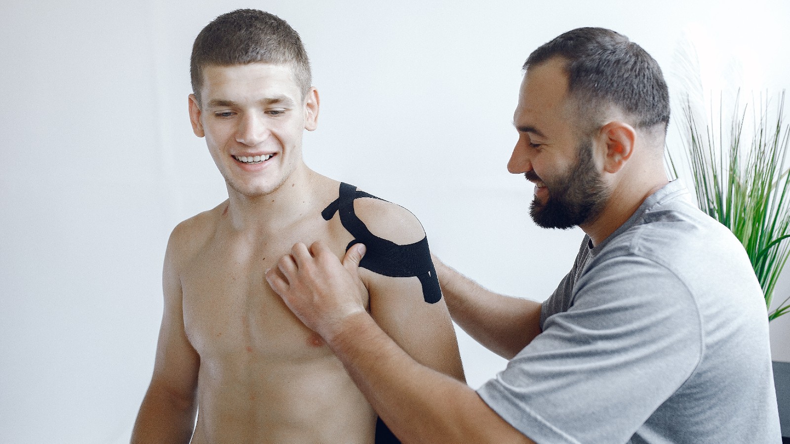 Physiotherapist treating a patient with a shoulder injury