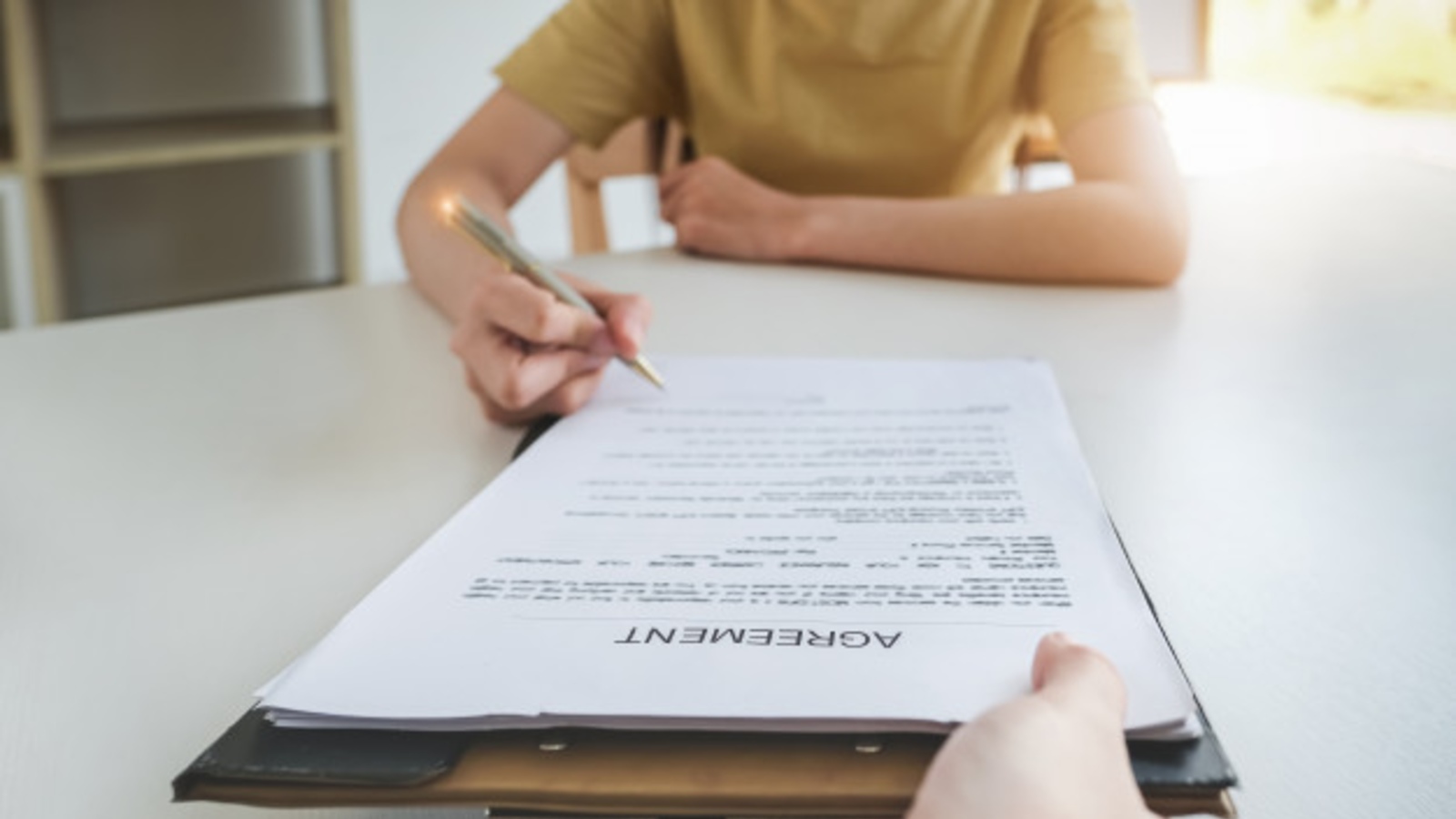 woman signs business agreement