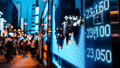 City street scene with current stock market displayed in window