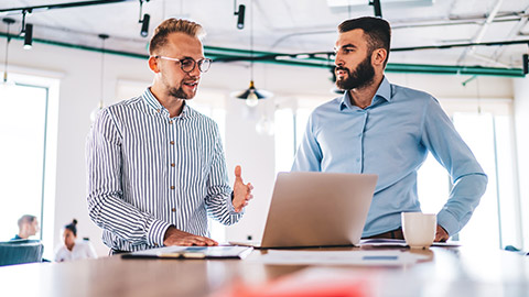 2 male professionals discussing marketing-related stuff