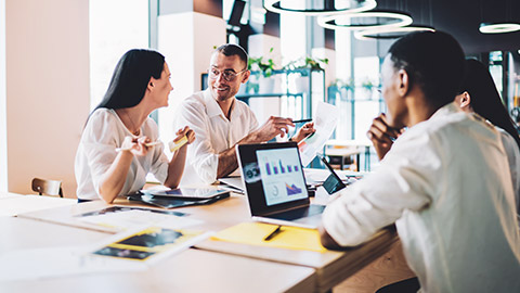 Diverse work group discussing project in a modern office