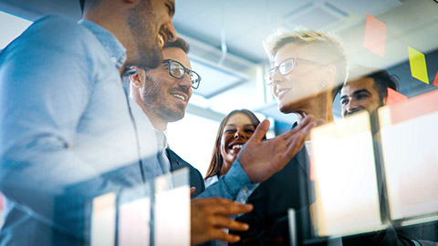 Group of business colleaguesdiscussing a project using sticky notes