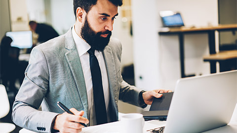 An accountant reviewing superannuation legislation on their laptop