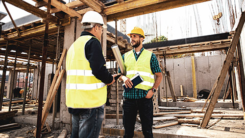 2 workmen on site discussing project