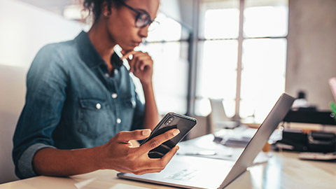 An accountant reviewing invoices on a smartphone