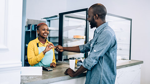 Man making to payment to cashier at a bakery