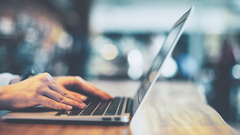 A close view of a female accountant about to subimt online paperwork