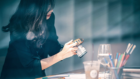 Woman taking picture of project on desk