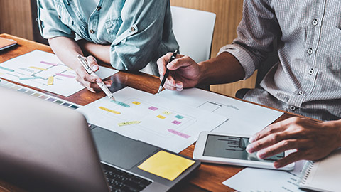 2 designers working on UX project at desk